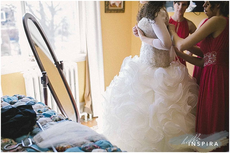 bride getting into her dress 